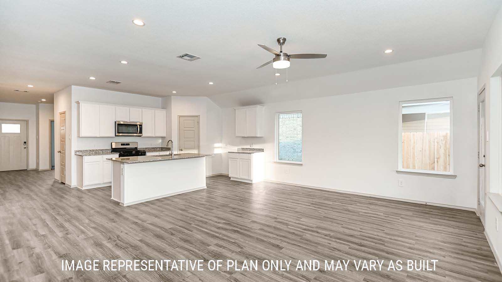 Lakeway living room with vinyl plank flooring and view of kitchen and front door.