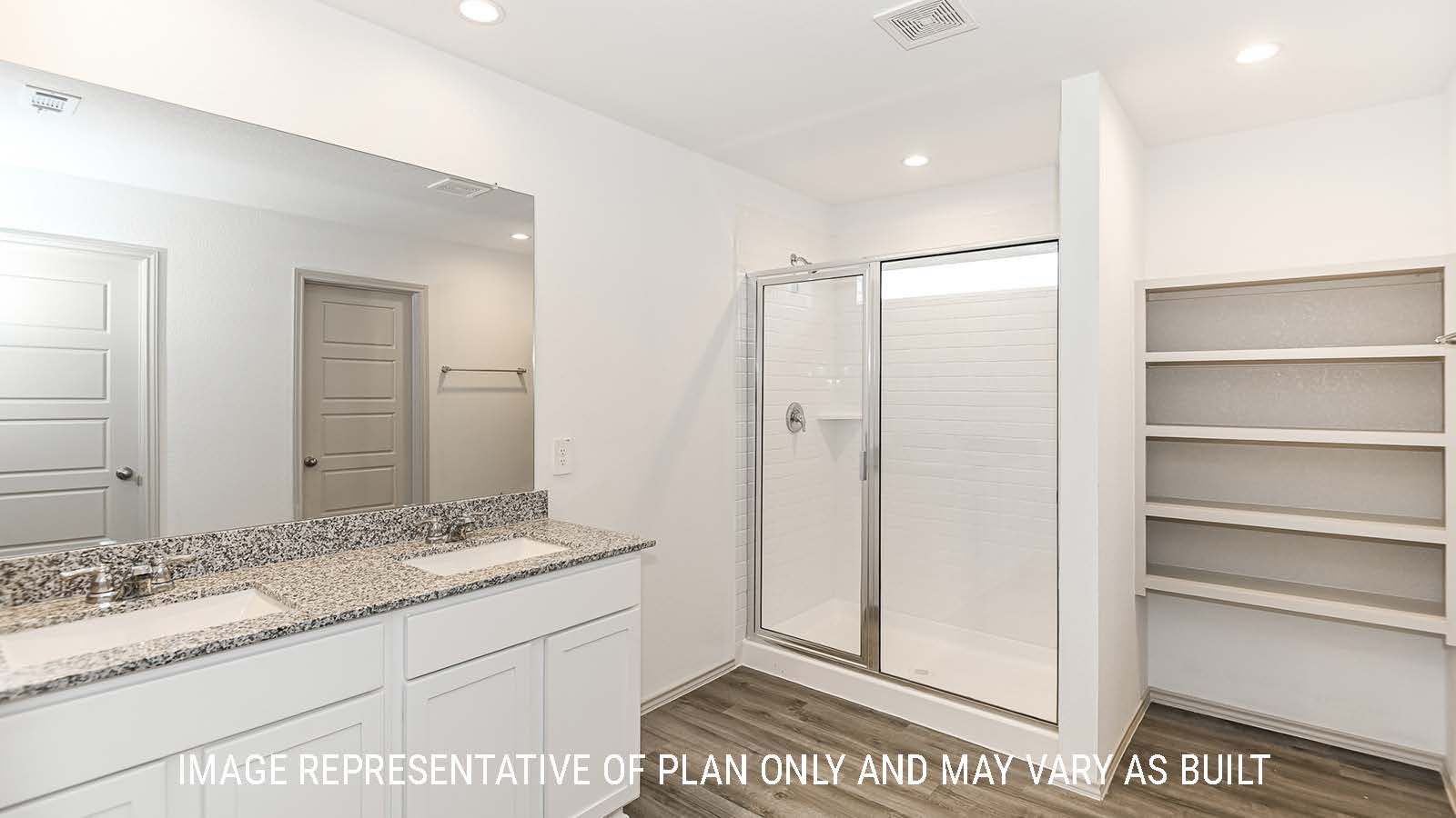 Lakeway primary bathroom with double vanity sink and walk-in shower.