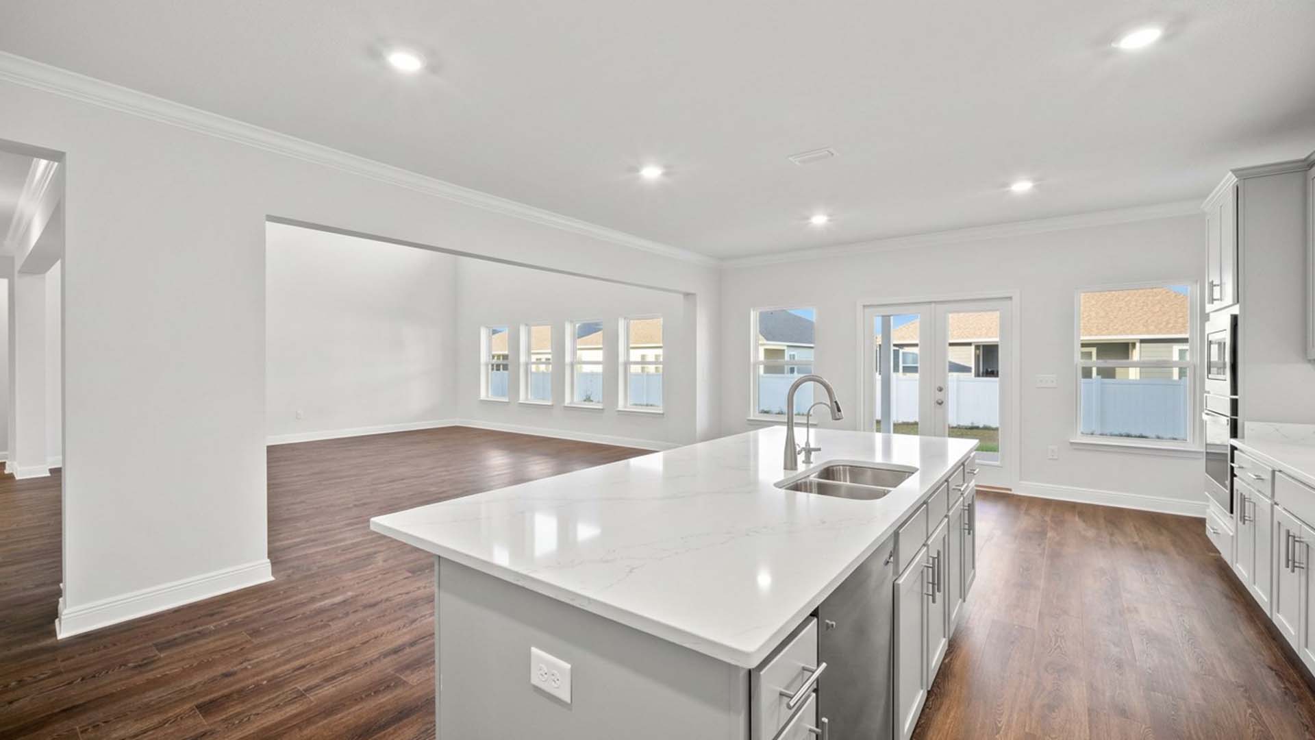 The kitchen is open with a center island and cabinetry for storage