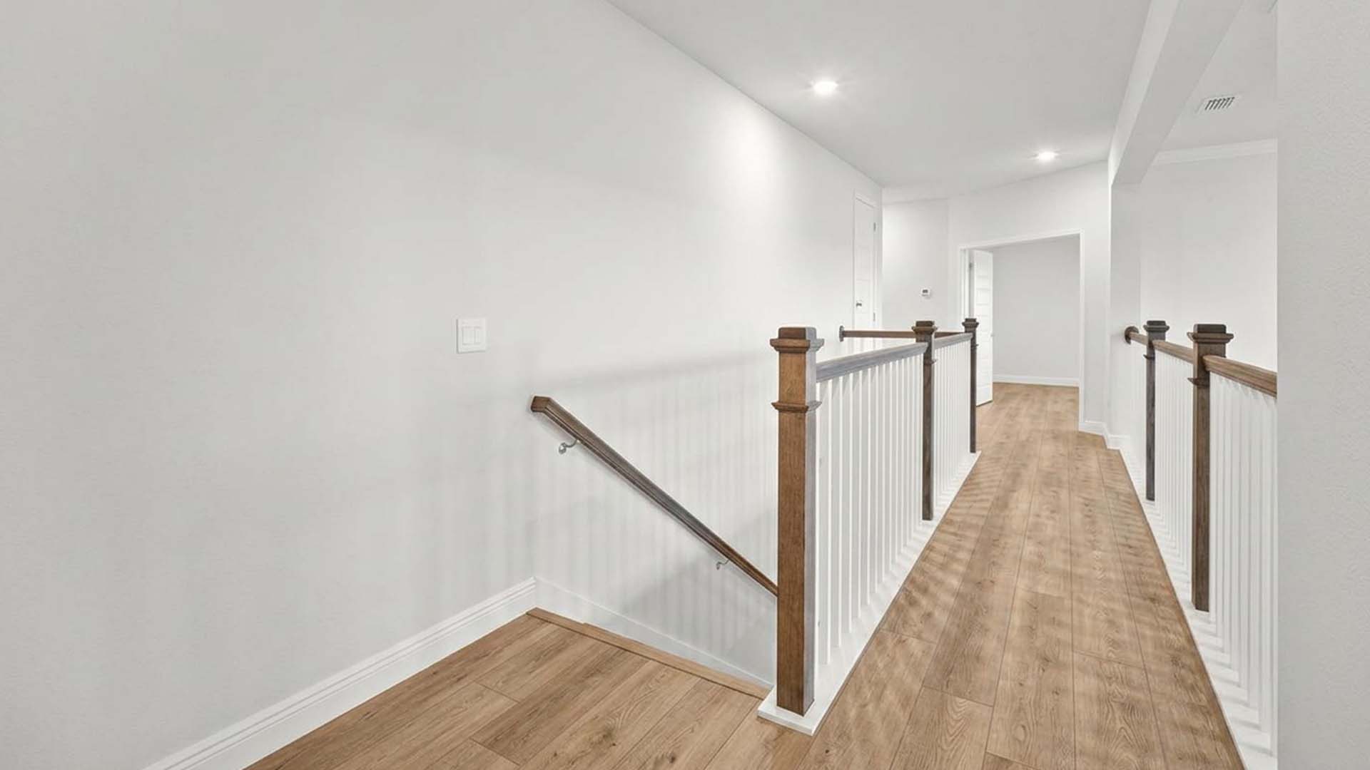 The second floor has EVP flooring and a landing area that overlooks the main level