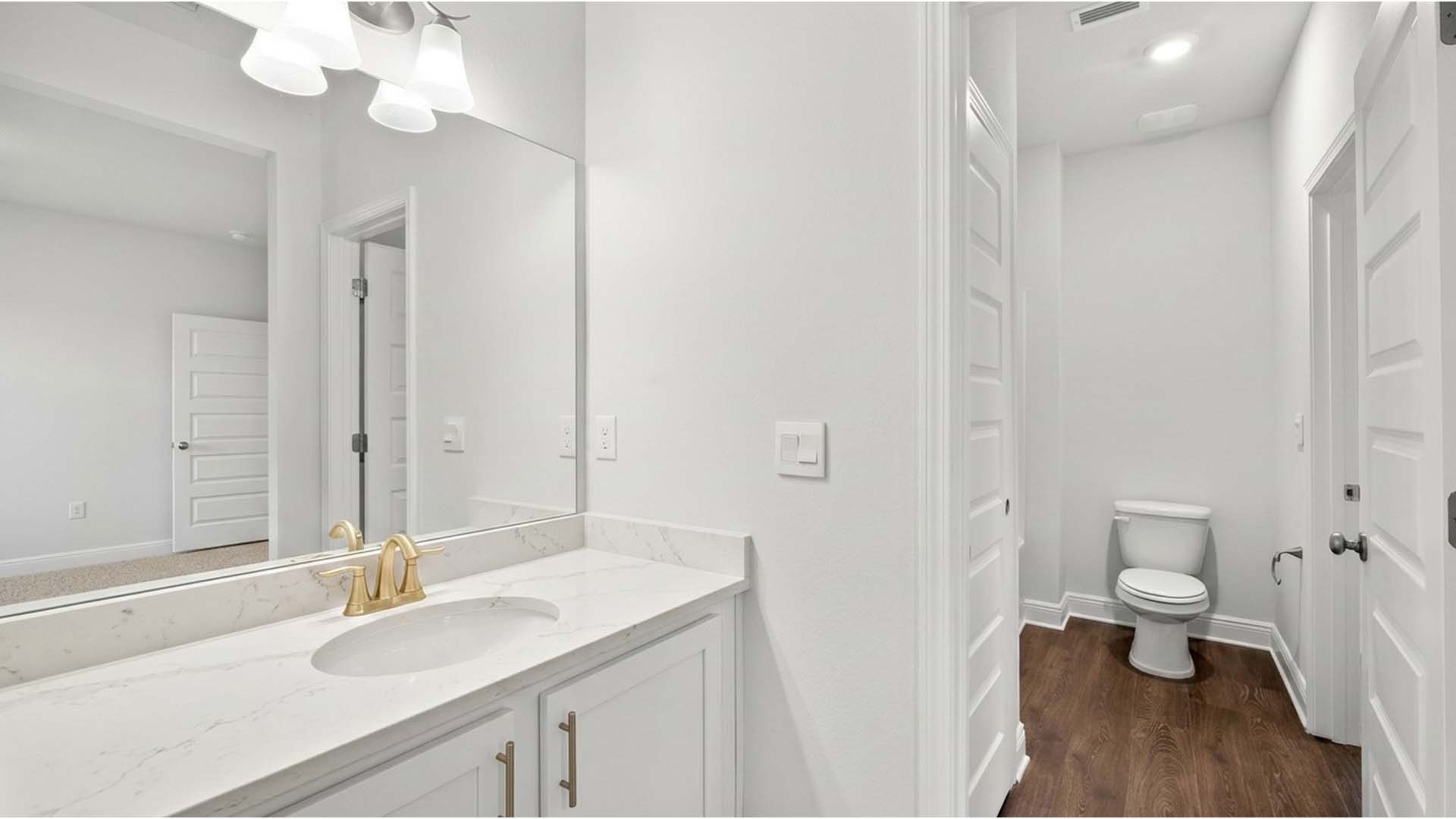 The vanities in guest bathrooms have quartz
