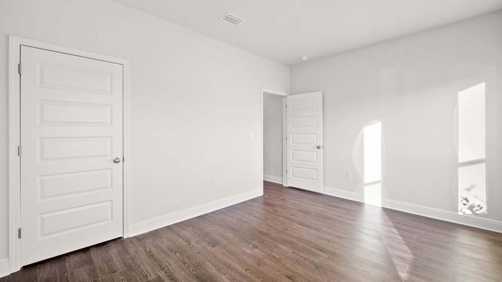 Guest bedroom on the second level has ample closet space