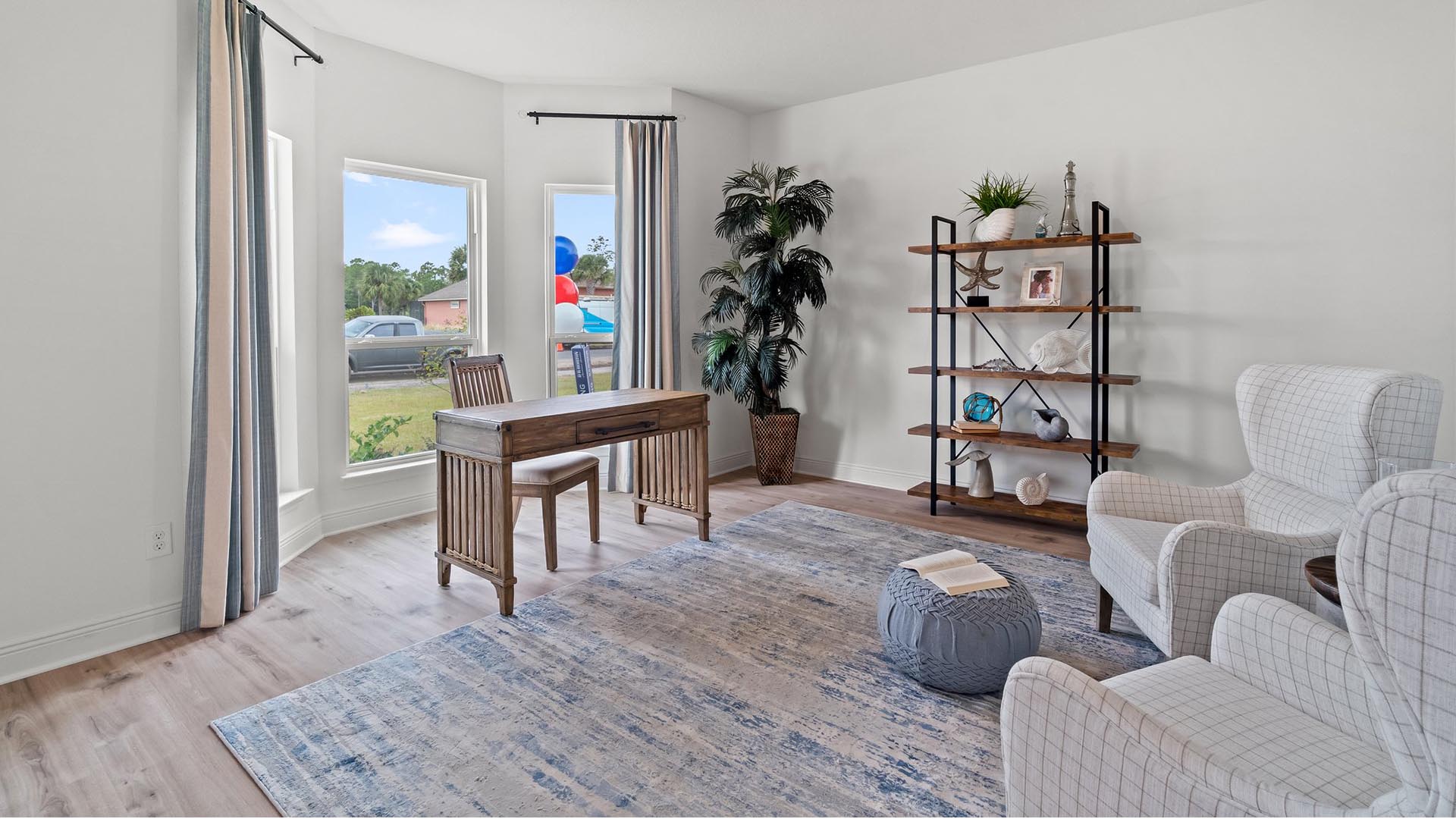 The spacious study off the foyer features an expansive window for natural lighting