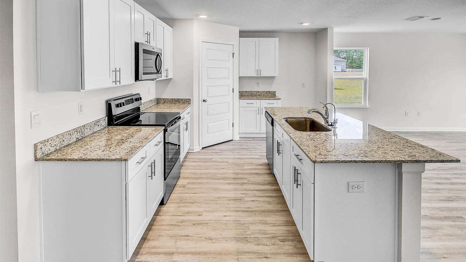 Beautiful white cabinetry contributes to the bright feel of the living space