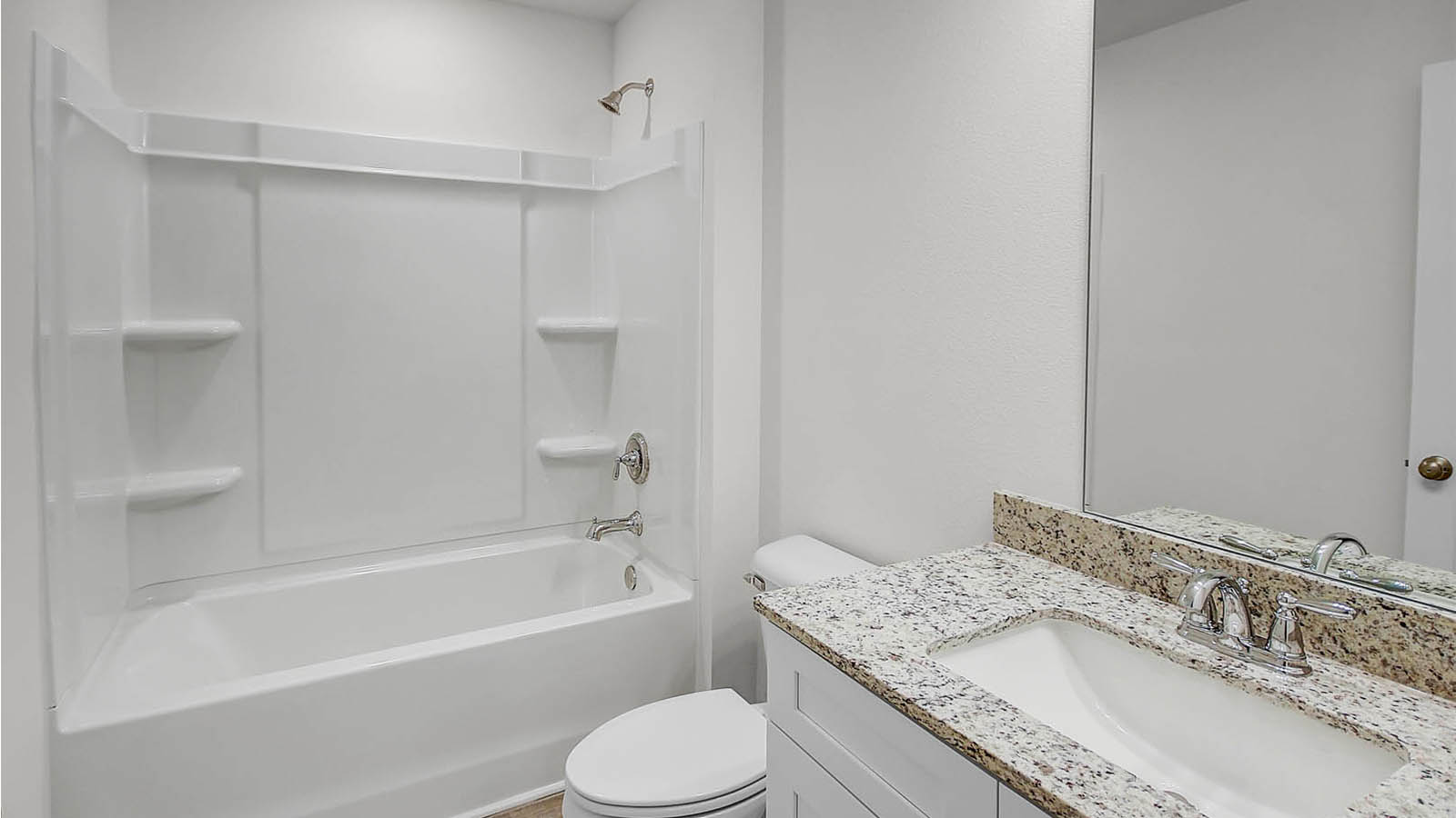 Shared bathroom of bedrooms two and three features a single vanity with lower cabinetry and shower tub combination