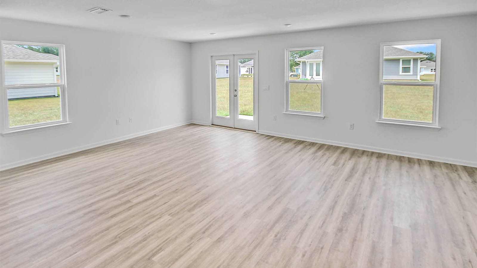 Spacious open concept floor plan with expansive windows for natural lighting