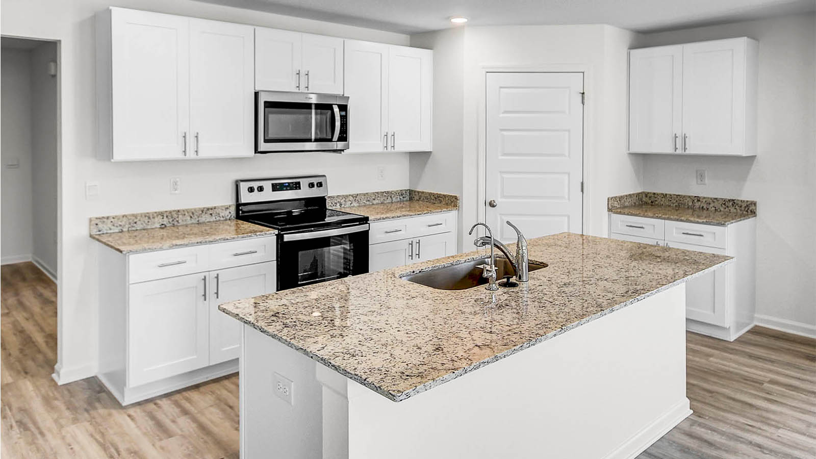The kitchen features a center island with sink and dishwasher