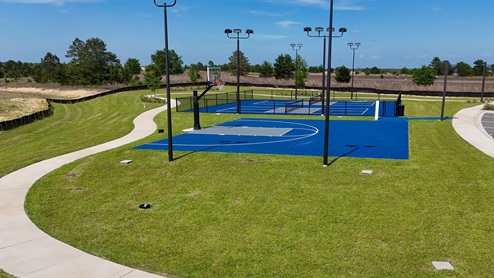 Basketball and pickleball courts at the community amenity