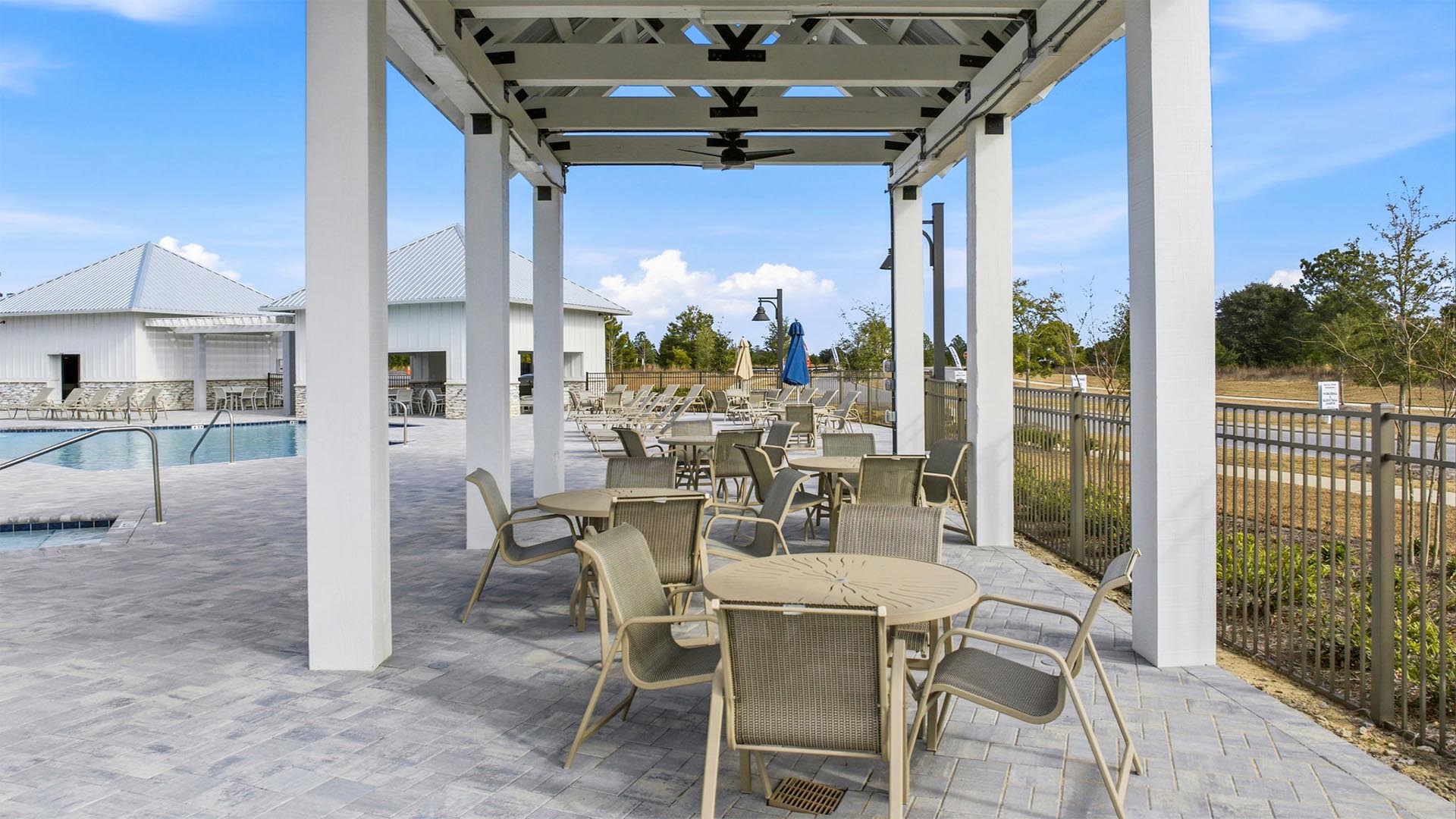 Covered patio area with tables and chairs