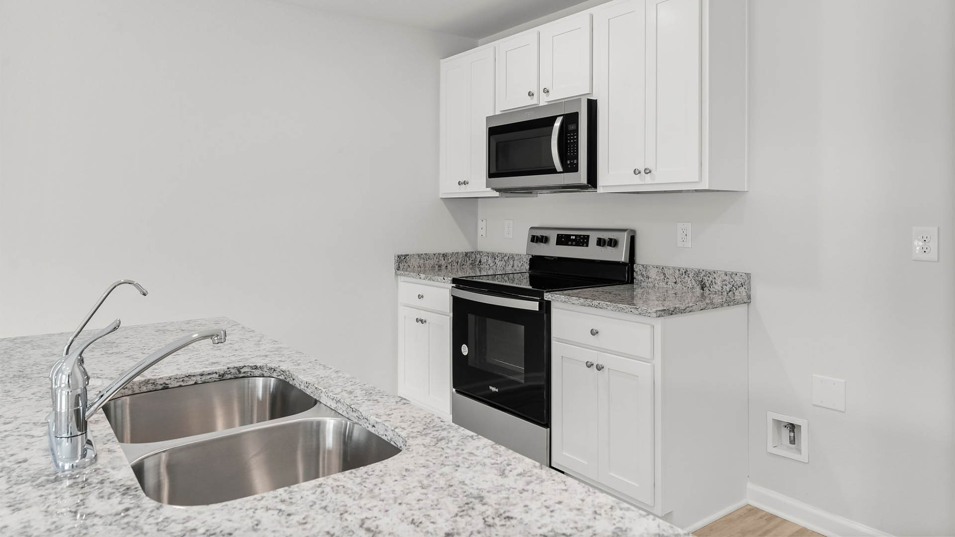 Beautiful kitchen with white cabientry and granite countertops