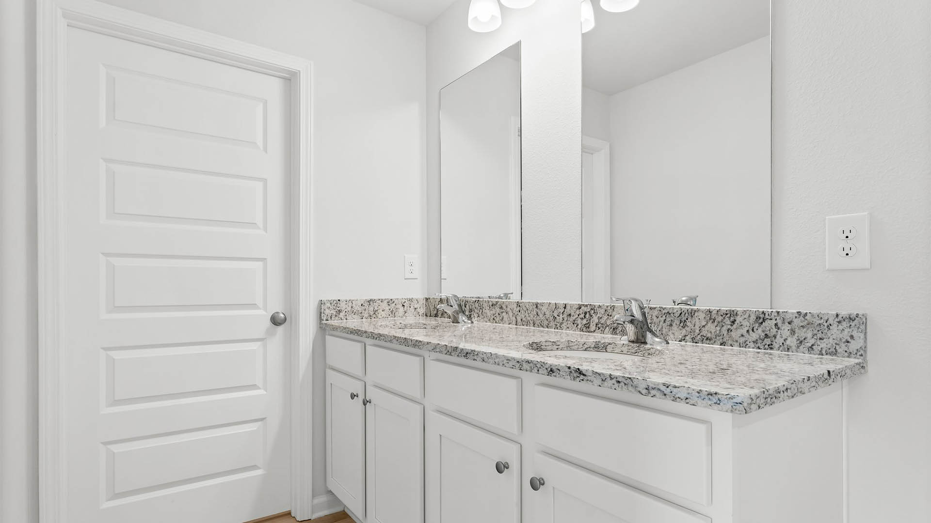 The primary bedroom has a private ensuite bathroom with granite countertops and EVP flooring