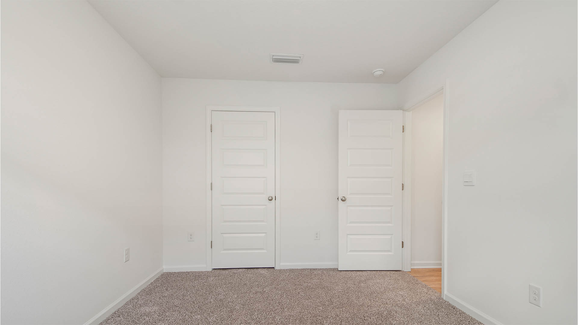 Two guest bedrooms are off the foyer