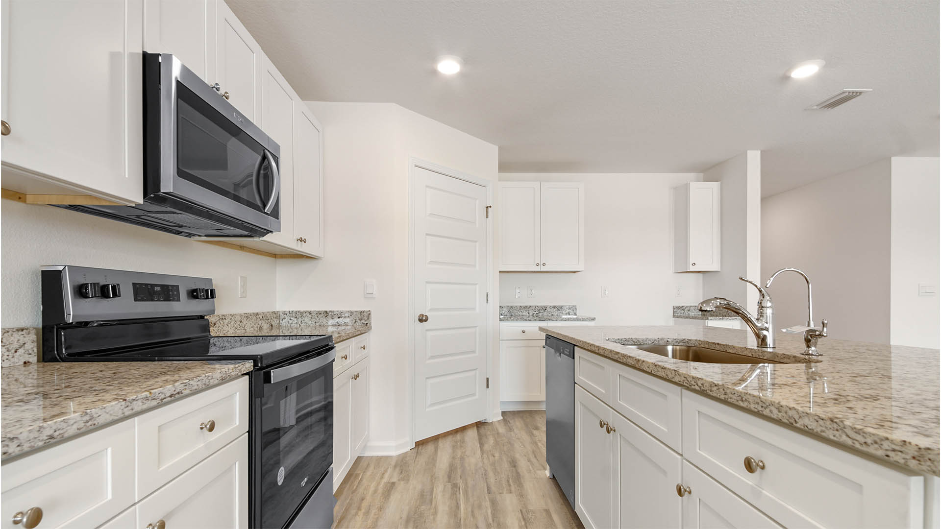 The kitchen features granite countertop and upper and lower cabinetry