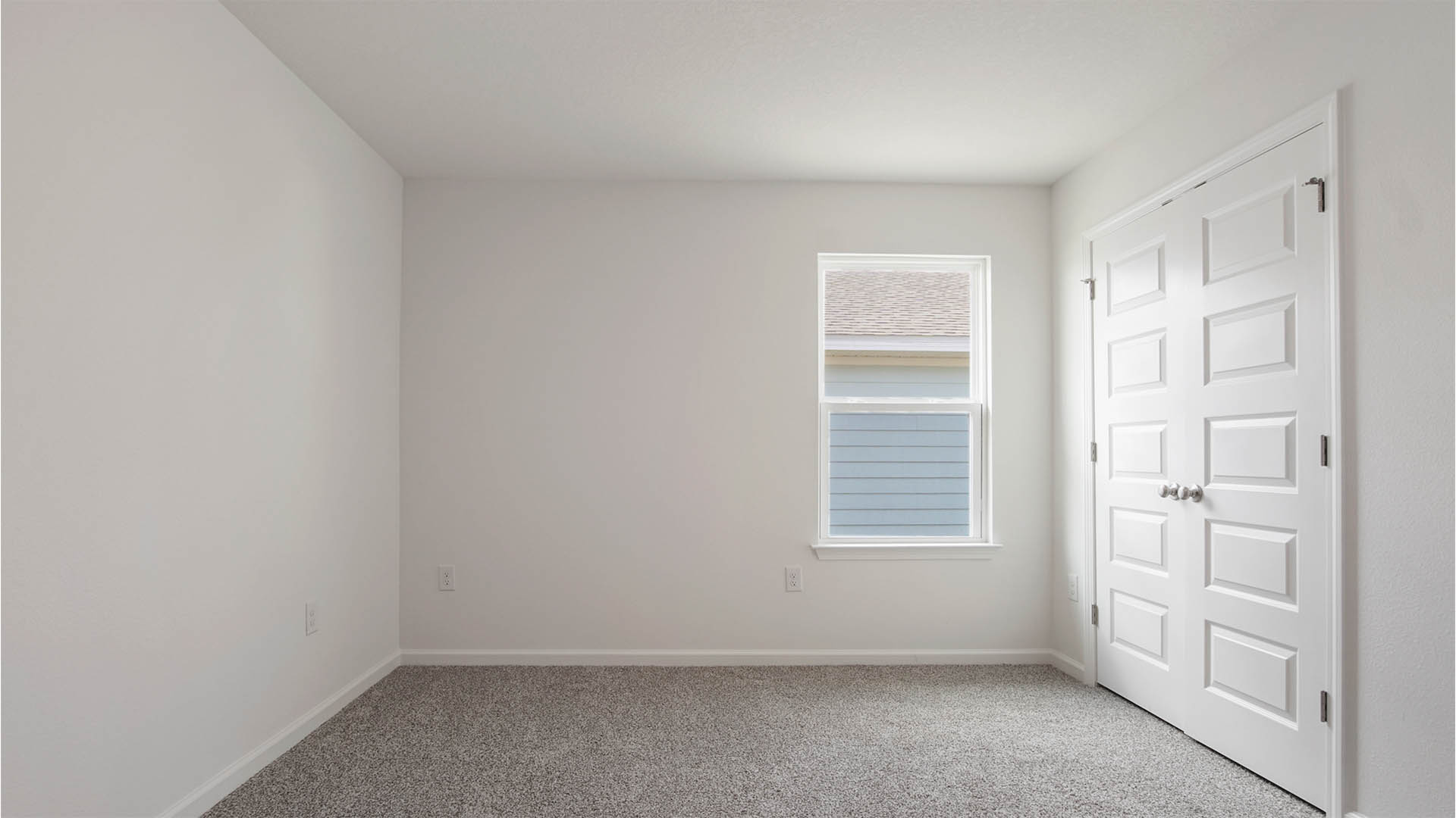 Bedroom three is spacious and features plush carpet