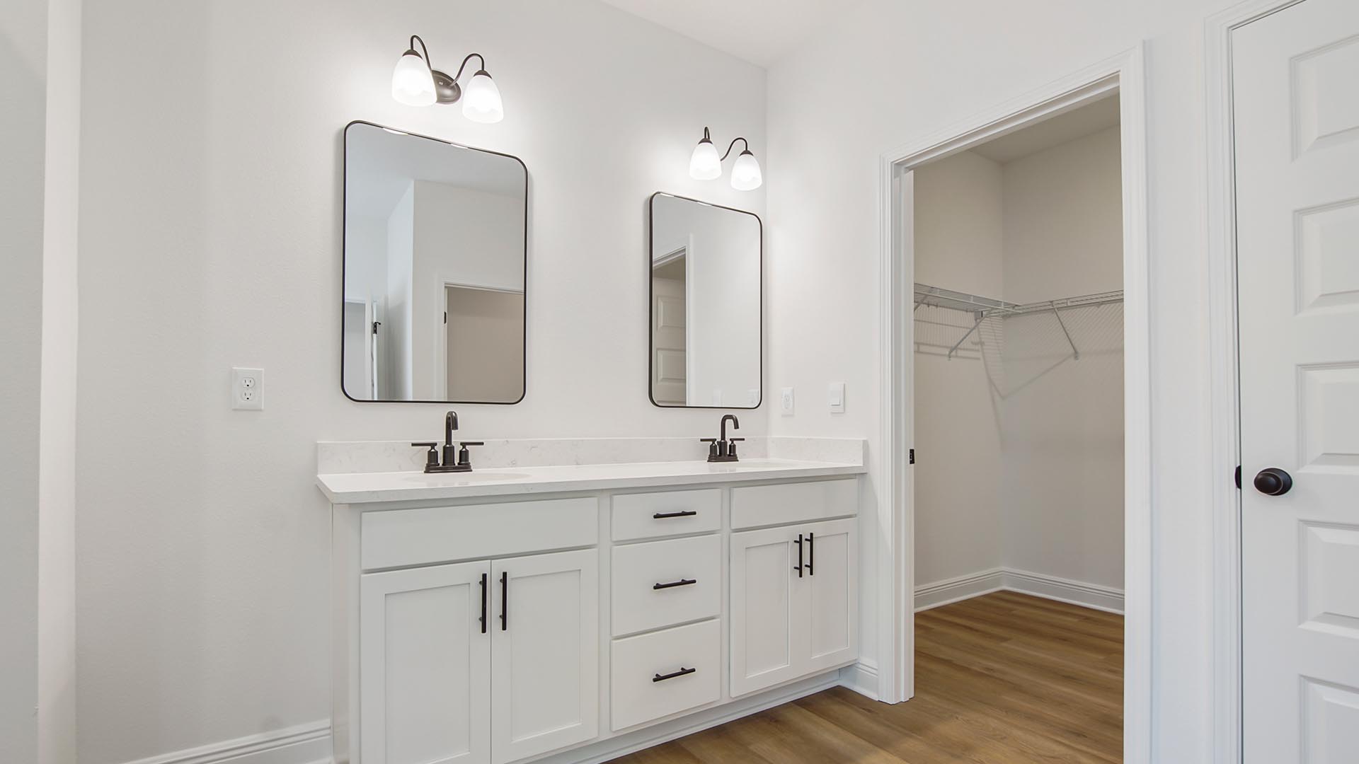 The primary bathroom has a dual sink vanity