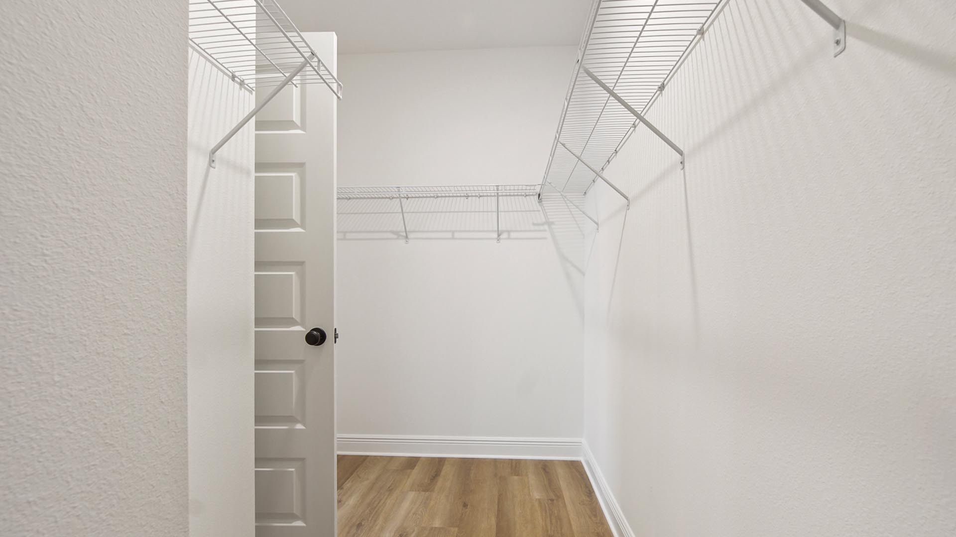 The primary closet has upper shelves