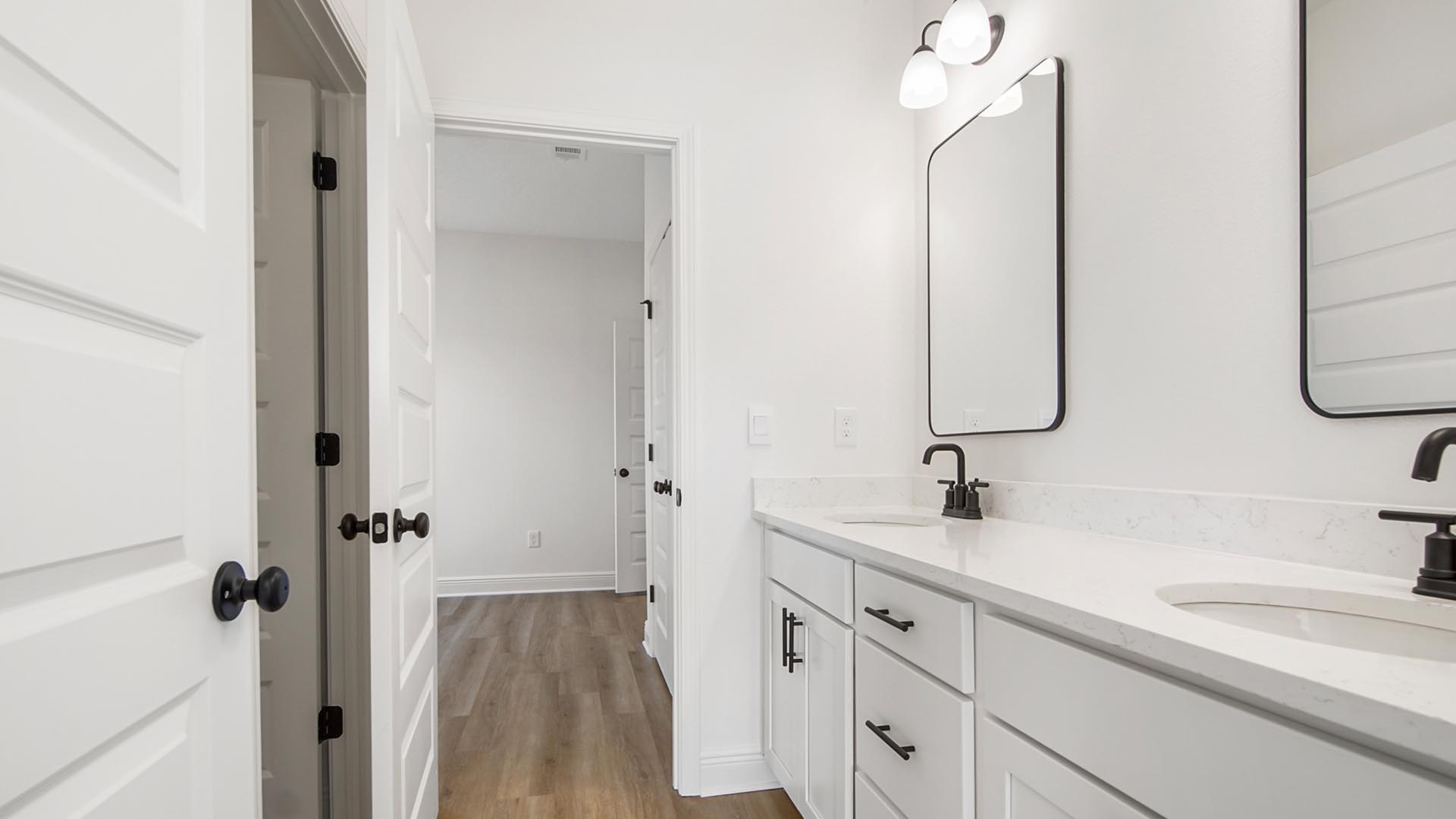 The shared bathroom has a two sink vanity