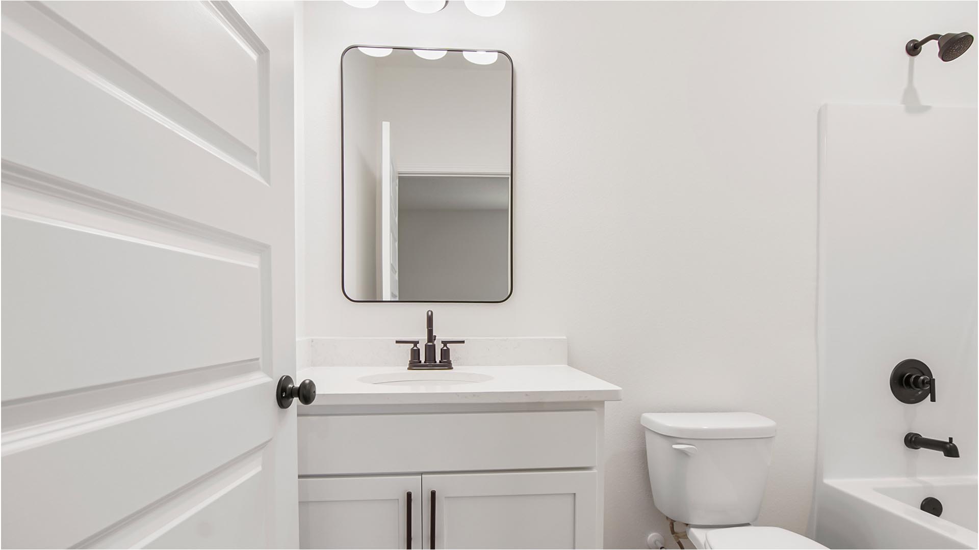 The bath in bedroom four has a single vanity with quartz countertop