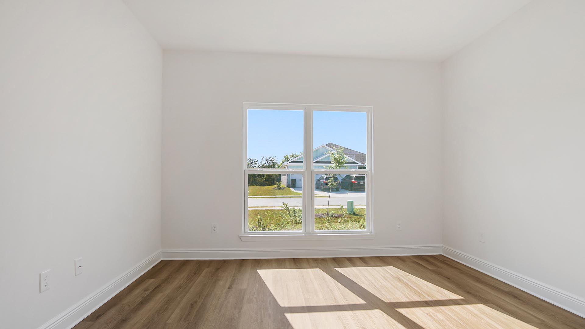 Bedroom two has a large picture window that allows for natural light