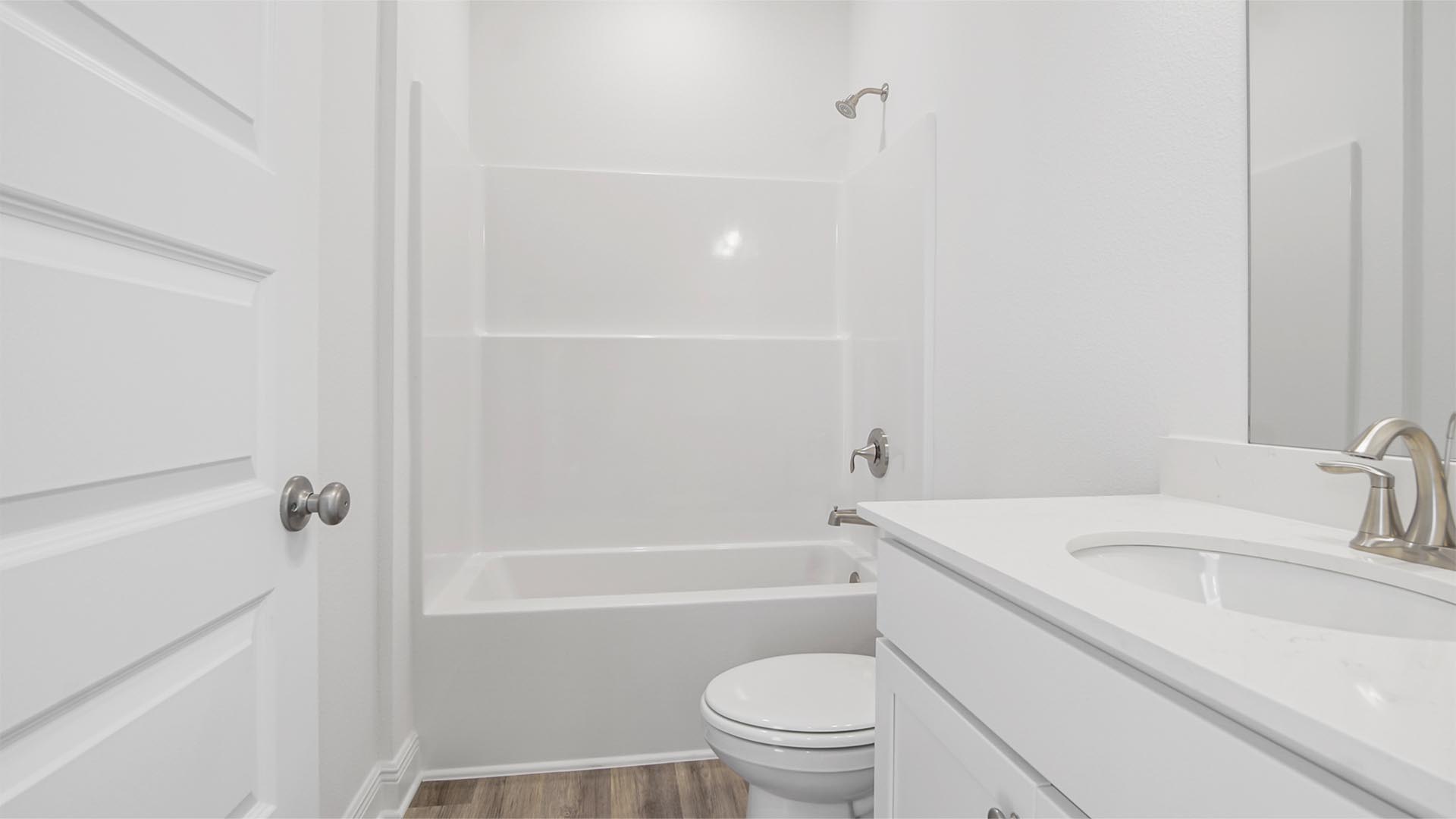 Full bathroom with Quartz countertop EVP flooring and shower tub combination