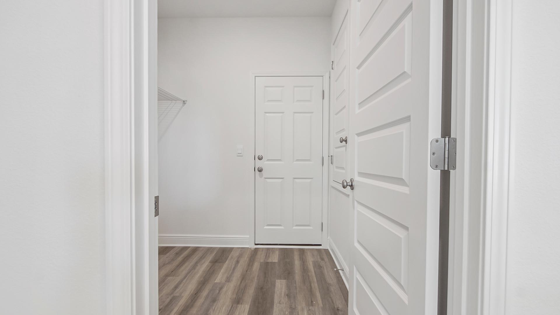 The Destin offers a large laundry room that leads to the three car garage