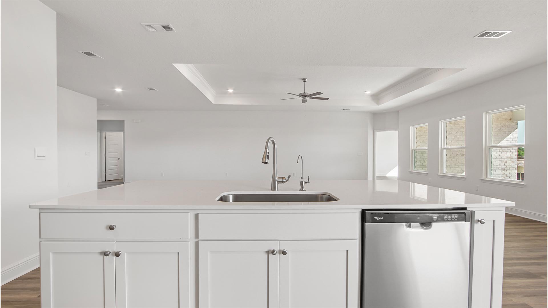 The Destin has a kitchen with center island elegant quartz countertops and upper and lower cabinetry