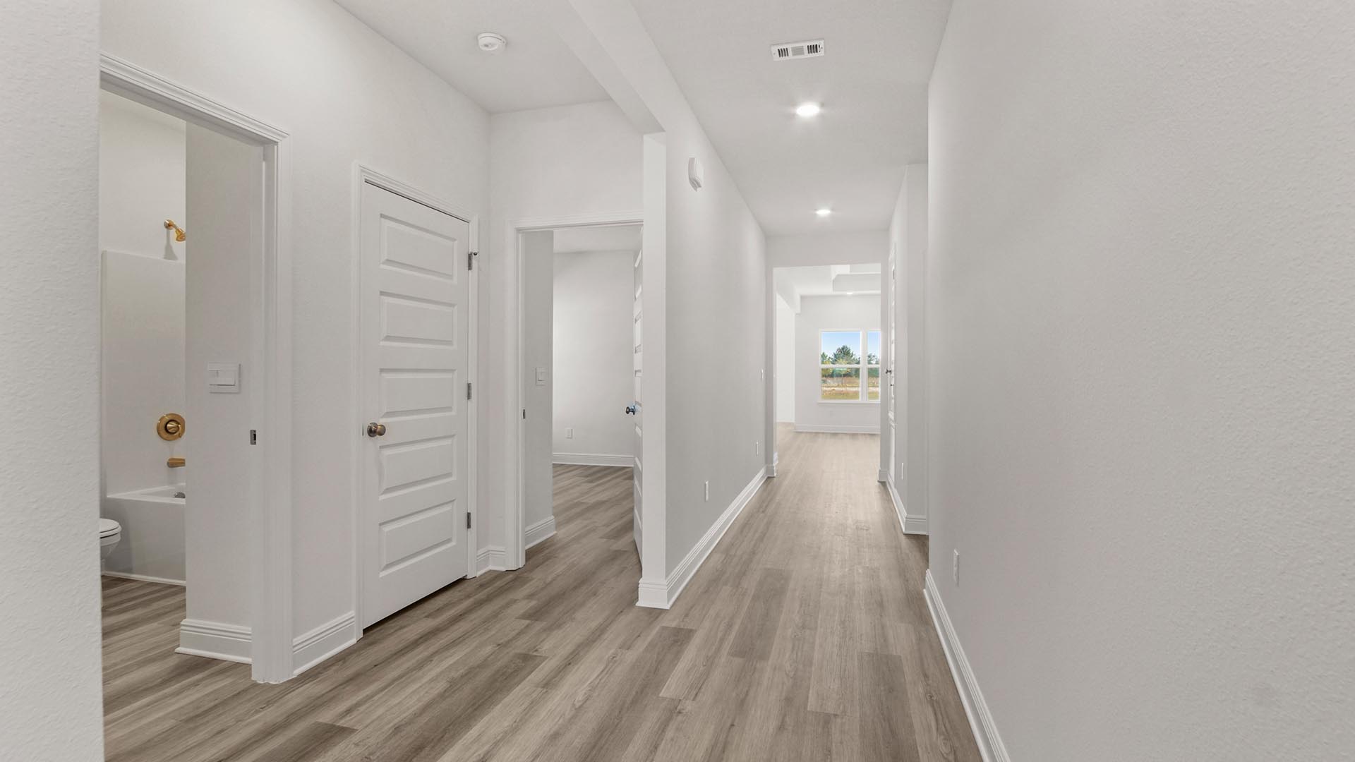 The entry hall leading to the open concept living area has EVP flooring
