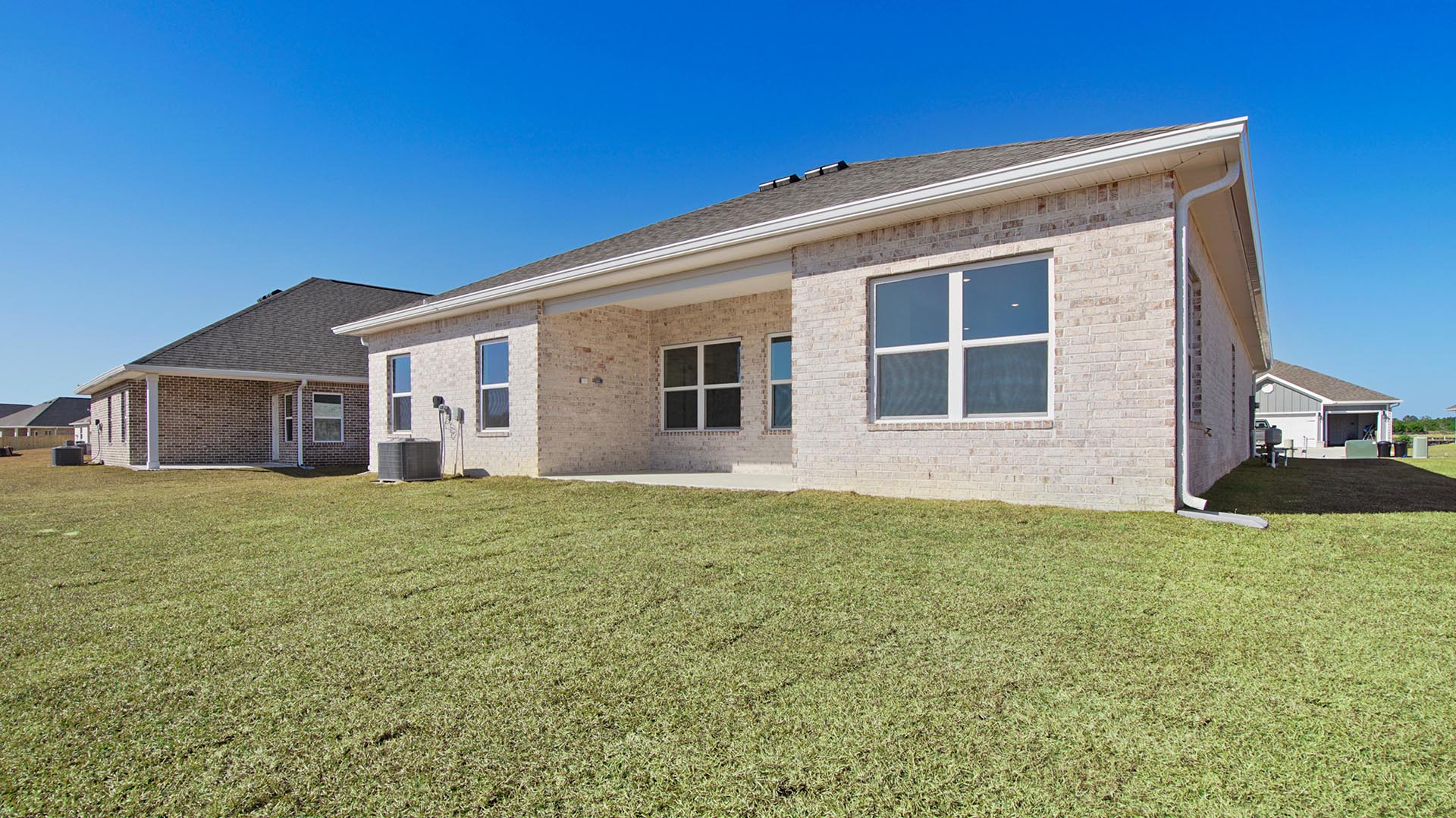 The back of the home has a covered patio with brick on all three sides. The front exterior has Hardie with brick skirt