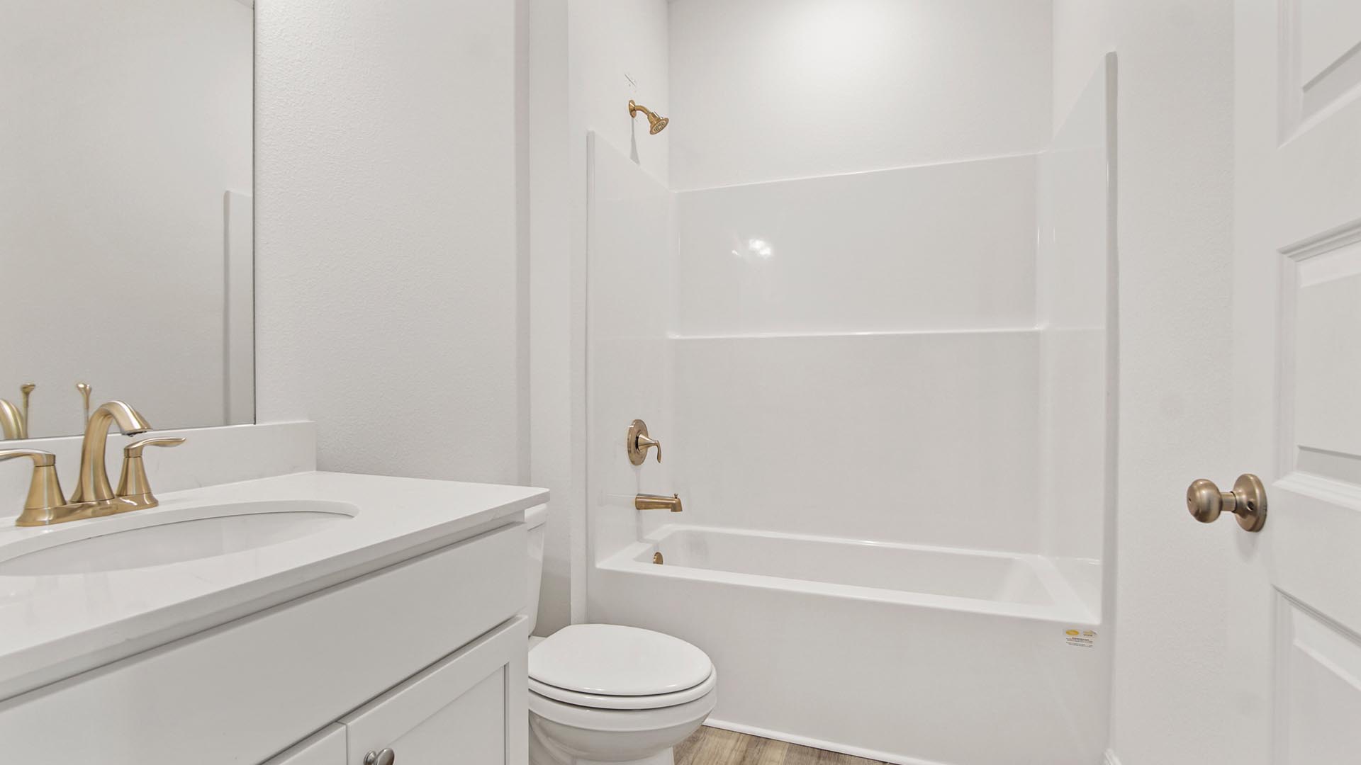 Bedrooms two and three share a full bath with a vanity and shower tub combination