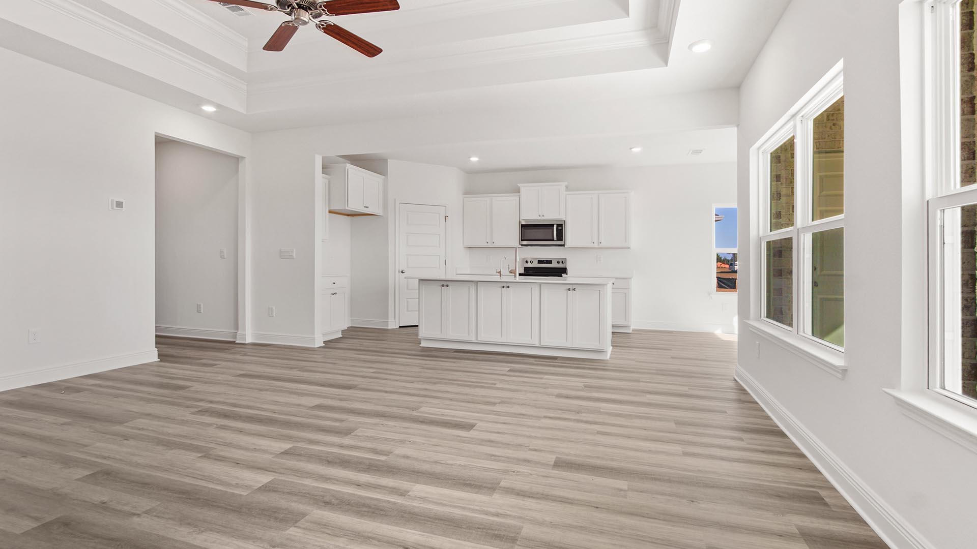 The open concept floor plan is illuminated with natural light by the numerous windows