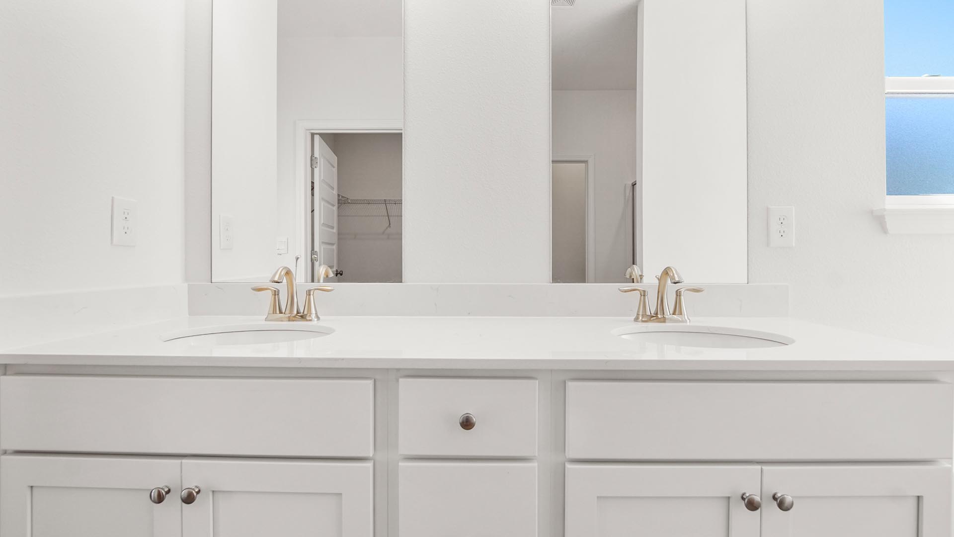 The vanity has quartz countertops