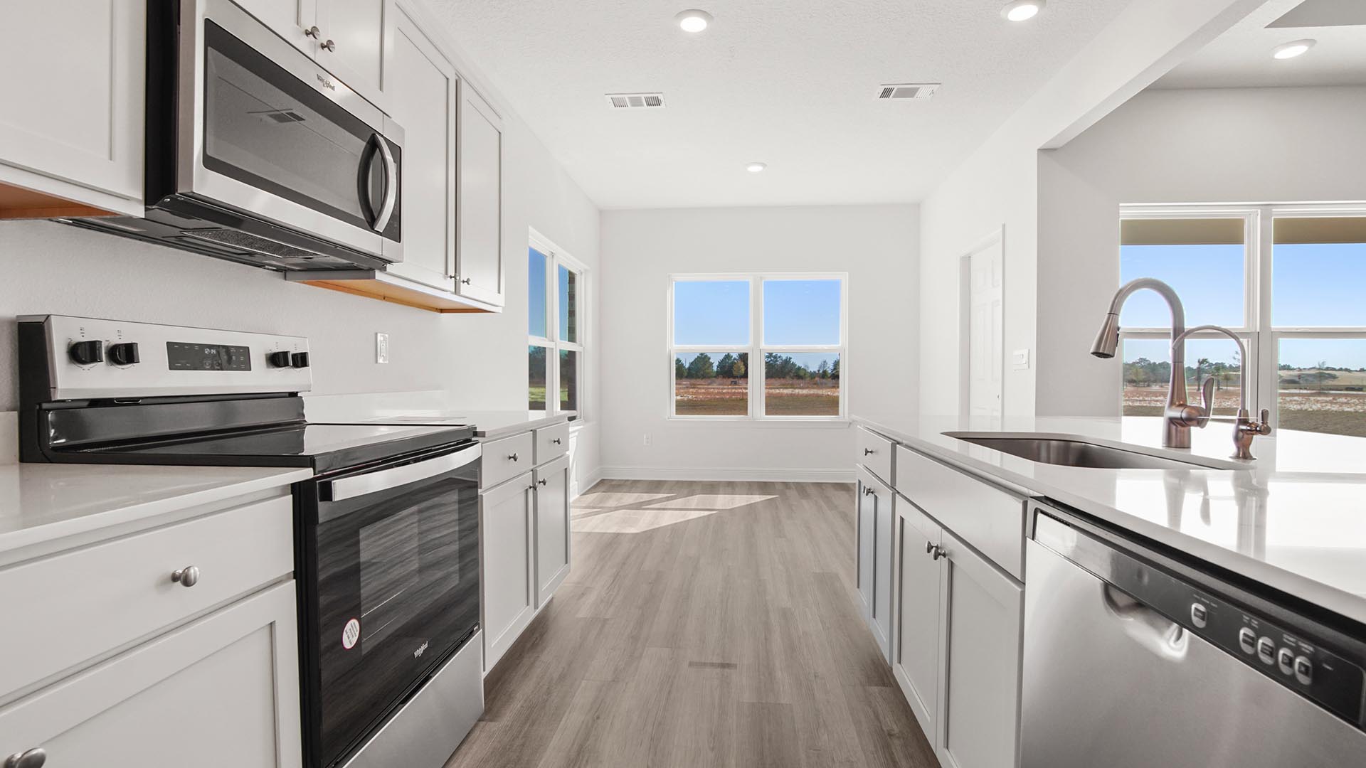 The kitchen has an appliance package that includes a stove microwave and dishwasher