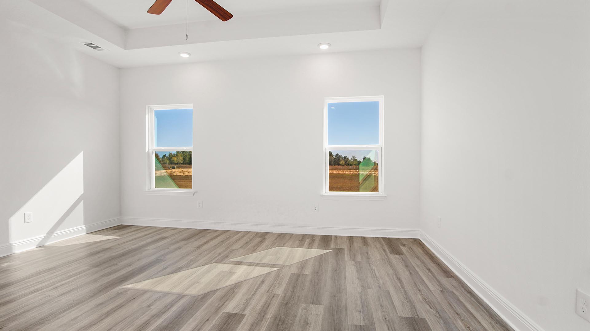 The open concept floor plan is illuminated with natural light by the numerous windows
