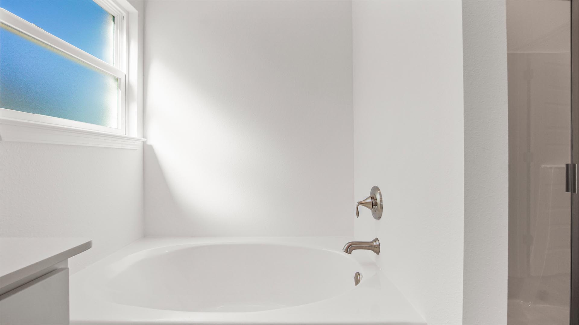 Separate soak tub in the primary bathroom