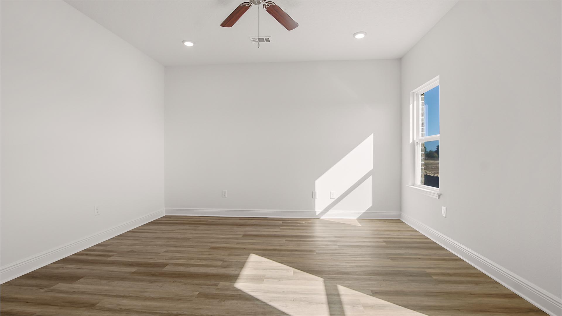 The primary bedroom has windows allowing for natural lighting