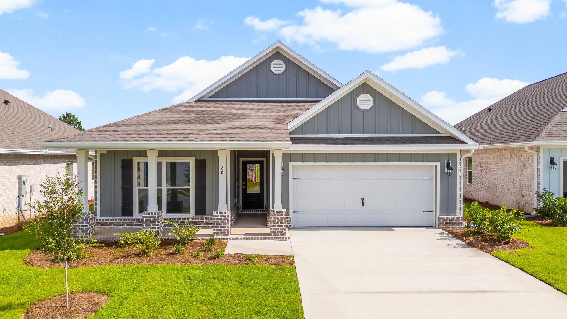 This home has a covered front porch and a two car garage