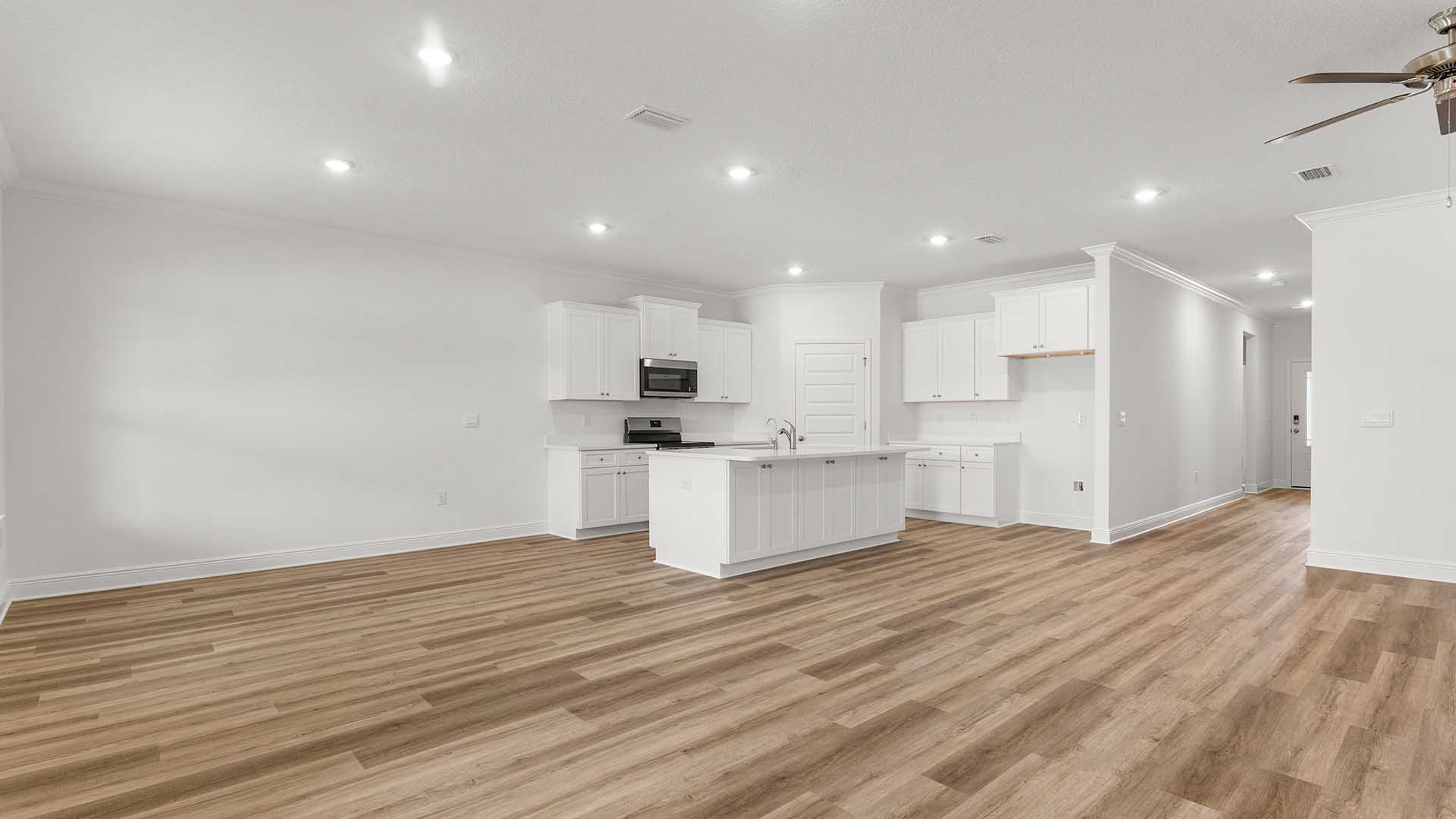 The spacious living area is adorned with windows for natural light