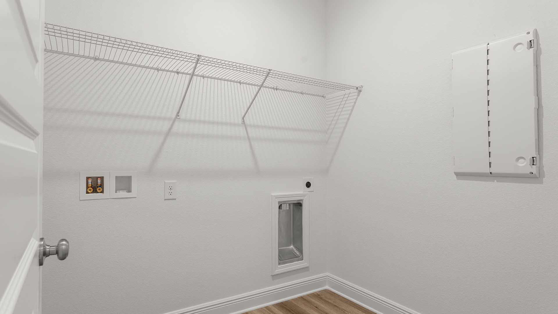 The laundry room is located off the hall leading to bedroom four near access to the garage