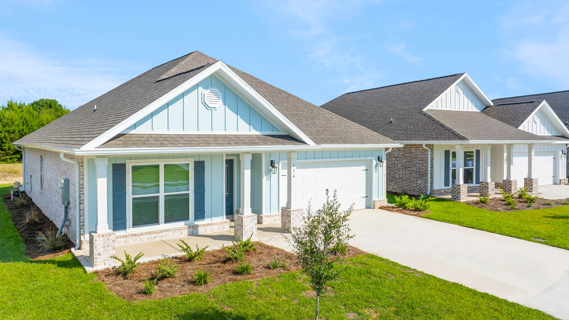 Photo of similar Rhett elevation showing brick skirt on the front with Hardie siding