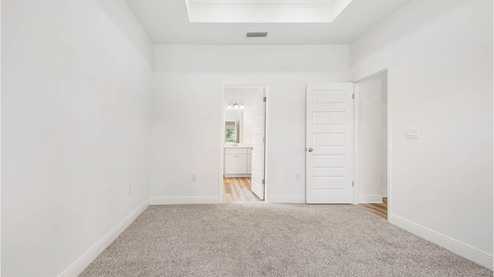 The primary bedroom has a private ensuite bathroom