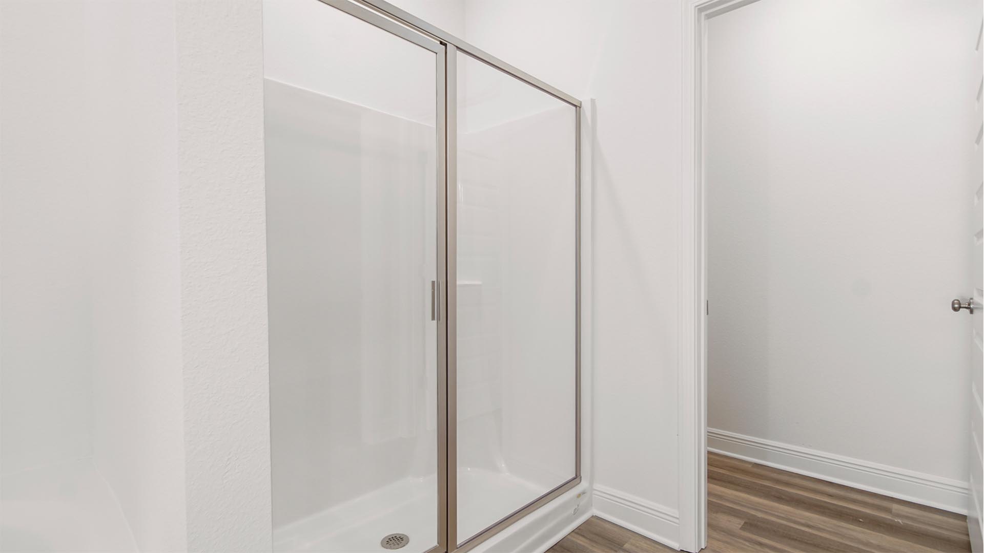 The shower features a glass enclosure