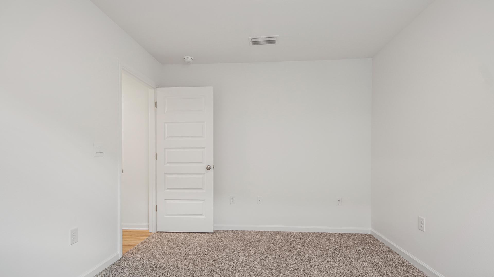 Guest bedroom four has carpet and ample closet space