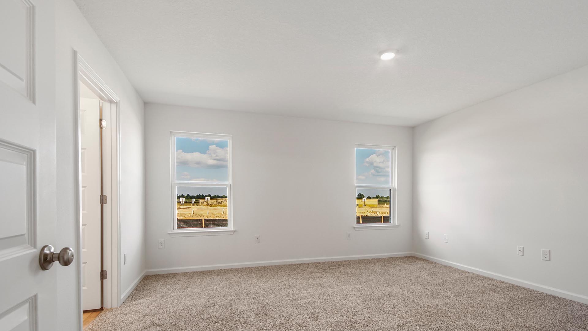 Primary bedroom is spacious and features a ceiling fan for comfort