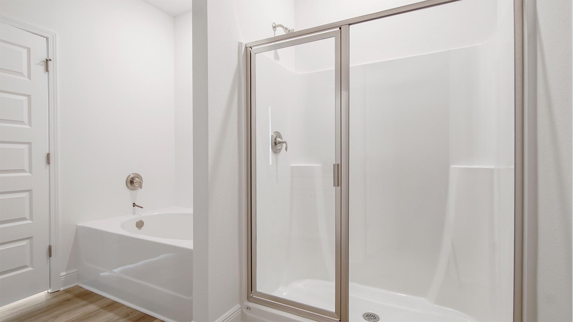The primary bathroom has a separate shower and soak tub