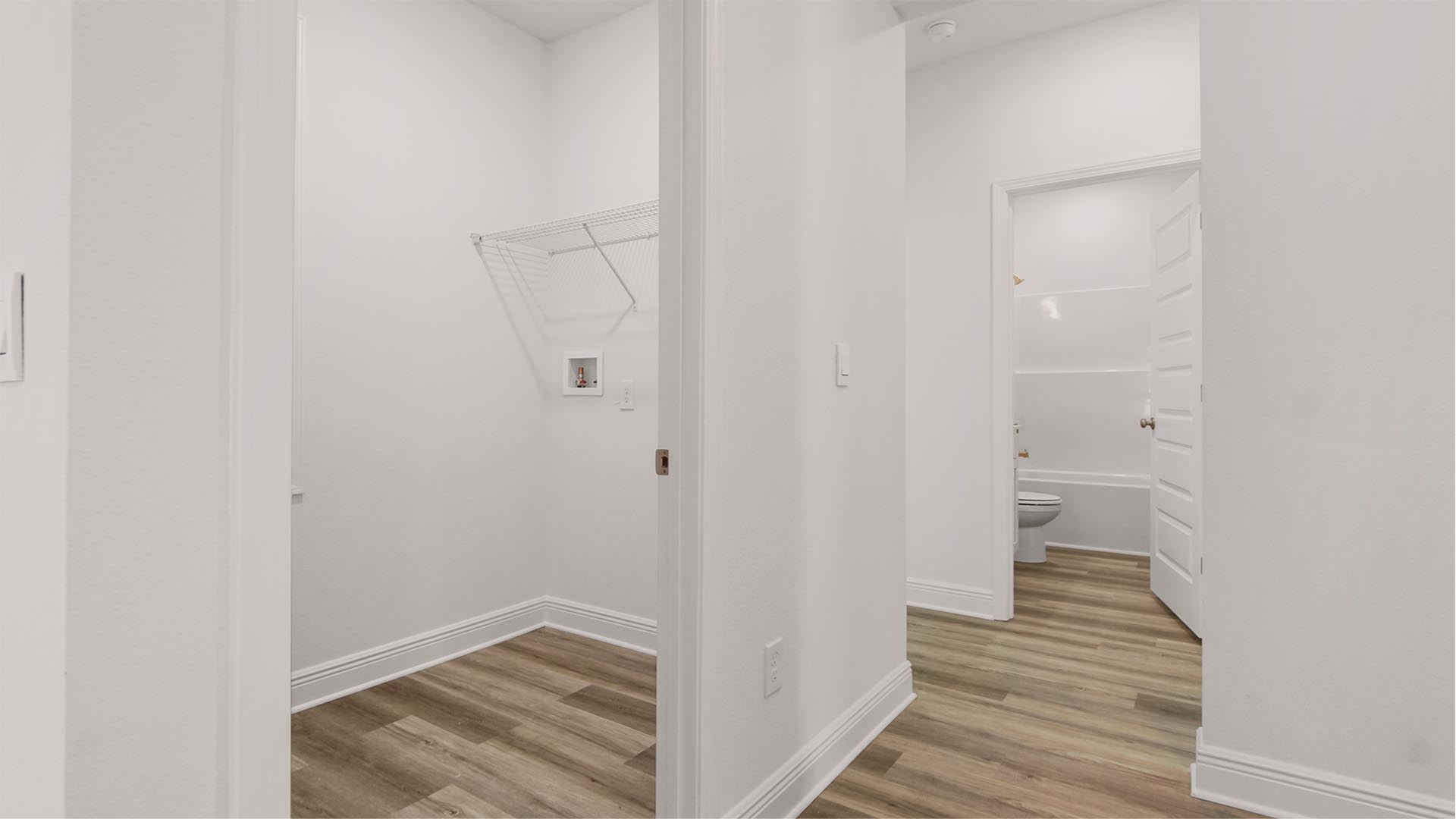 Hall leading to laundry and bedrooms two and three