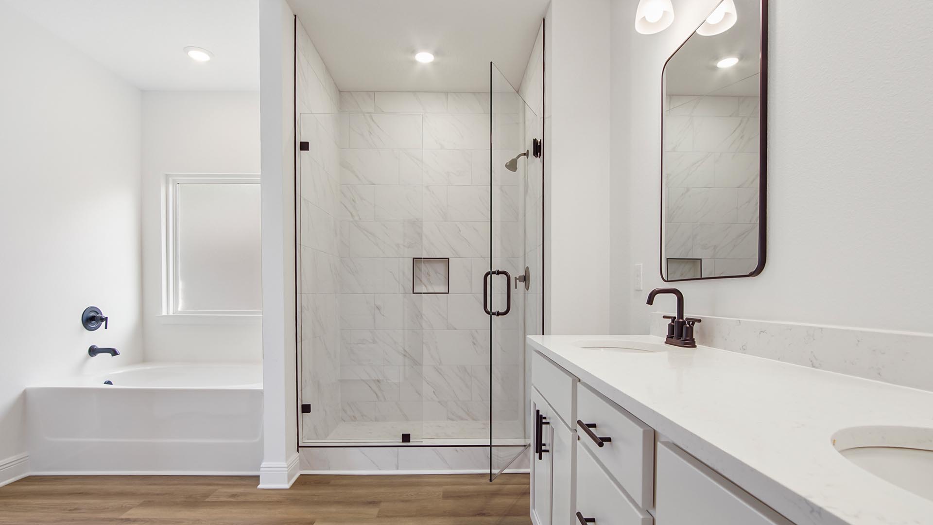 The primary bathroom has a tile shower with glass enclosure