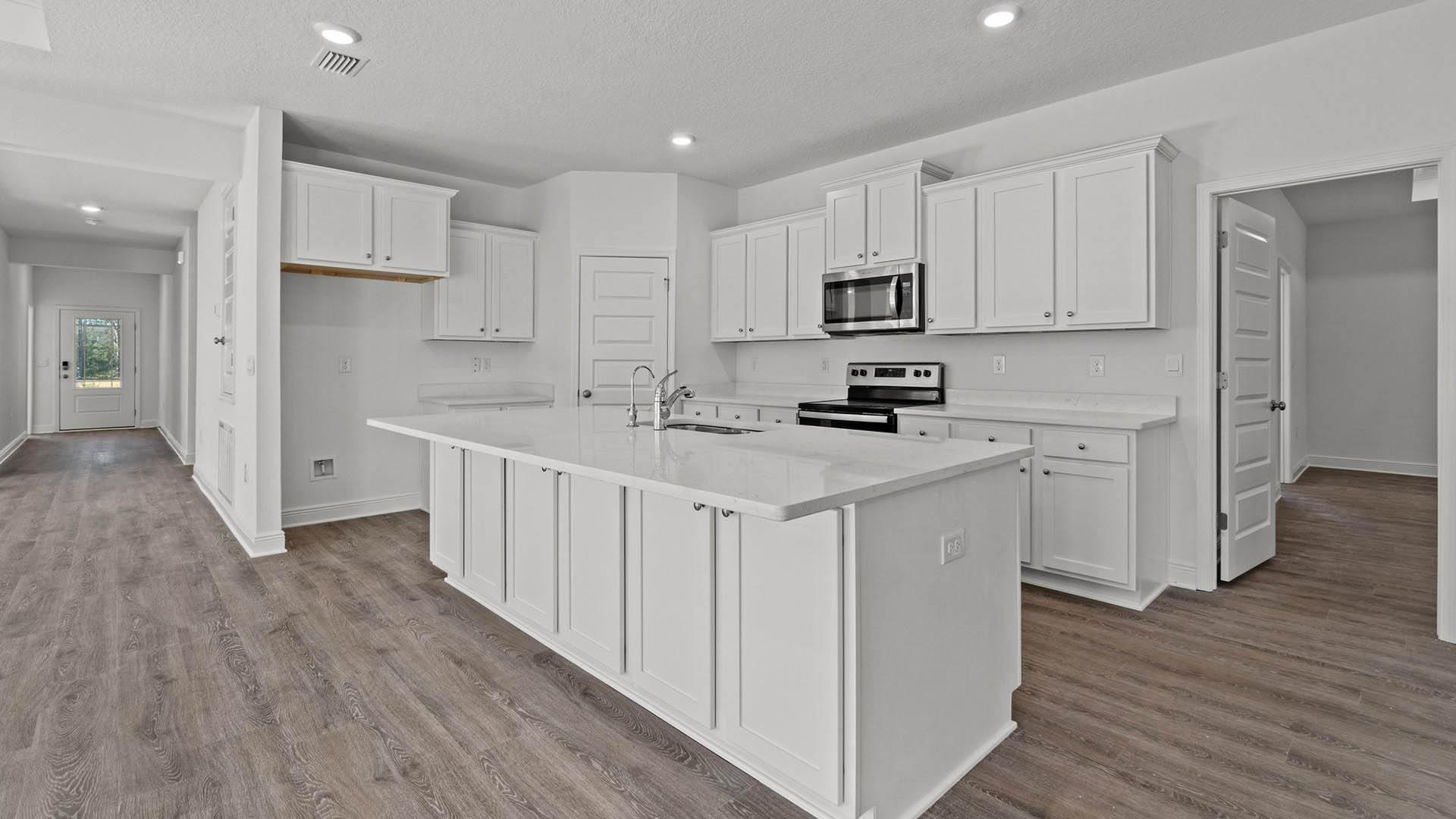 Spacious kitchen with beautiful white cabinetry and EVP Flooring