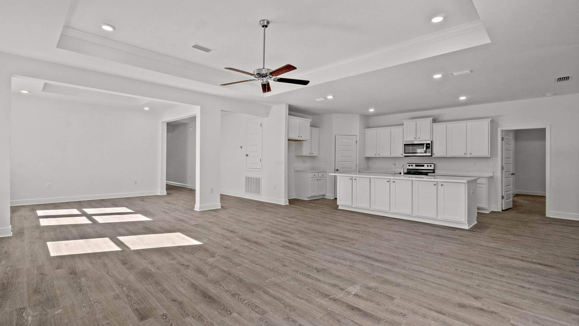 Open living area features trey ceilings and has an appointed dining room