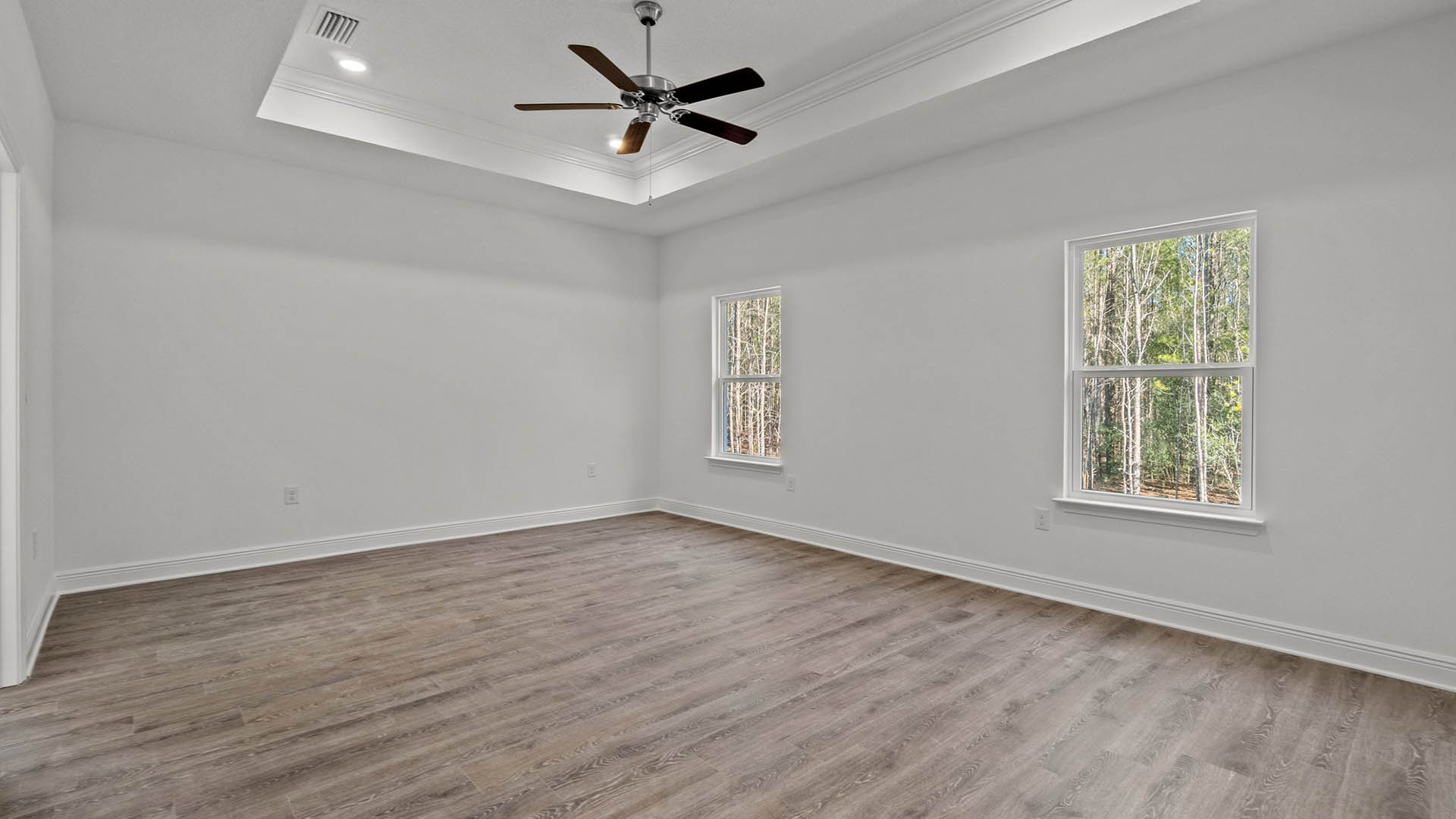 Primary bedroom of the Camden features trey ceiling and fan with EVP flooring