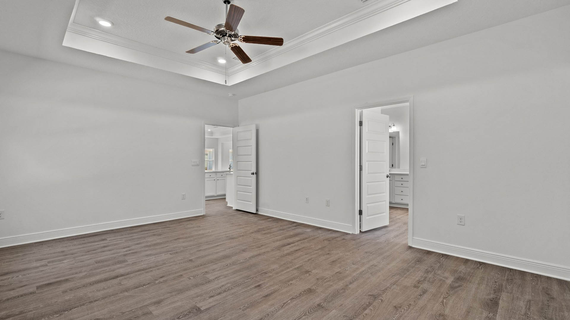 Large primary bedroom is accessed from the breakfast area and kitchen and has a large ensuite bathroom